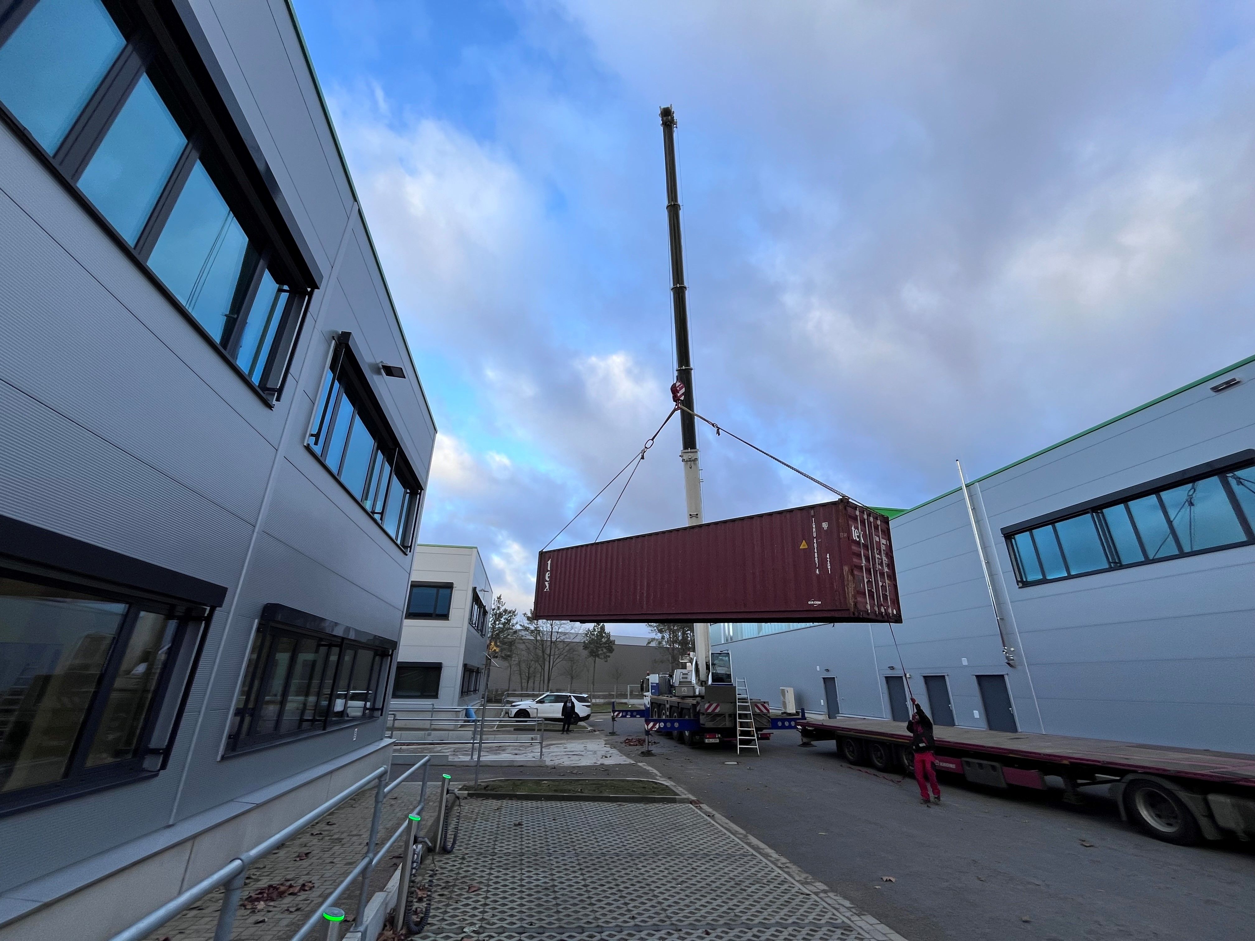 Mobile crane placing 40 foot storage container