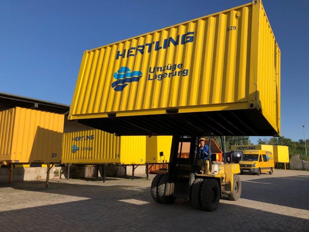 HERTLING forklift lifts storage container