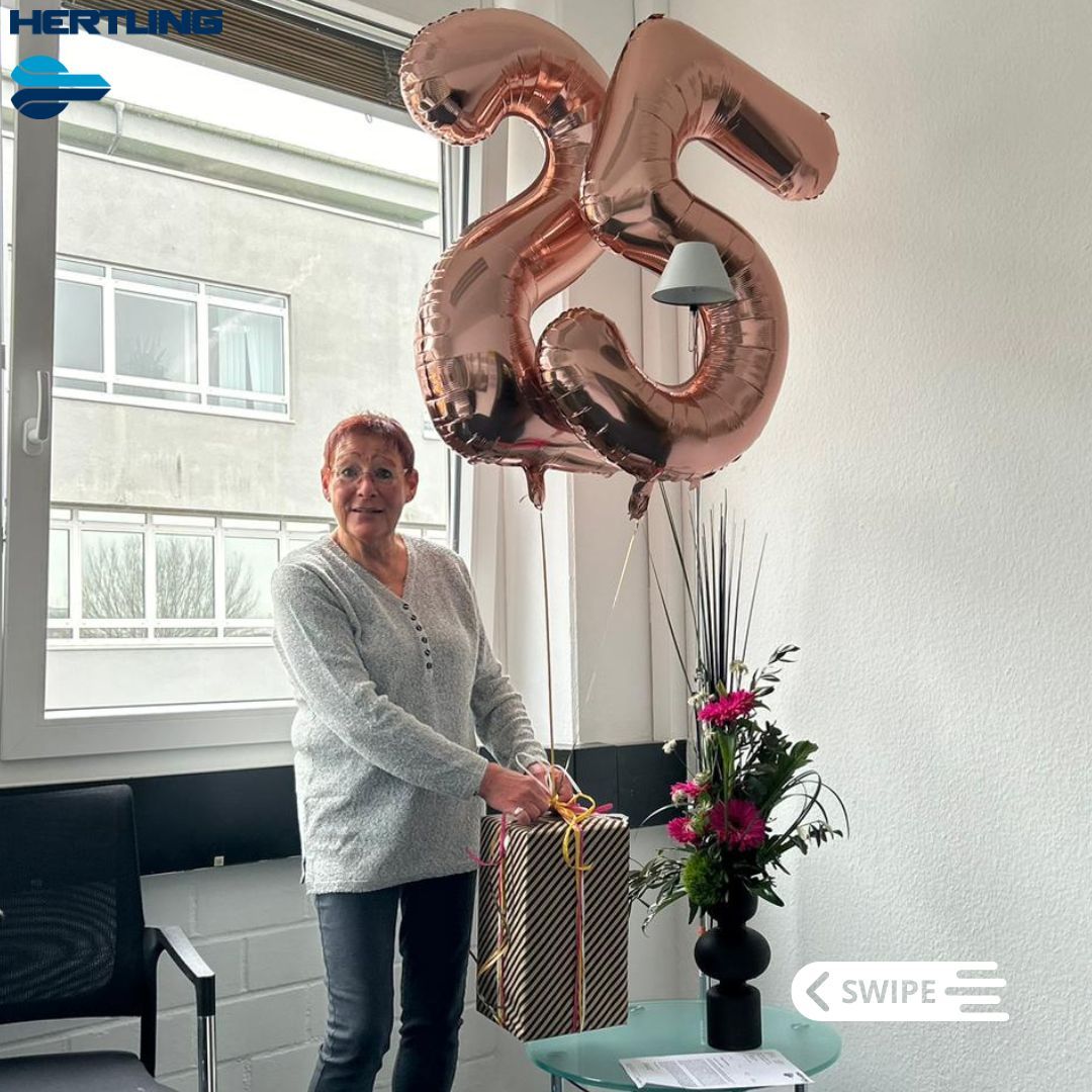 Photo of Brigitte Möbus holding a gift