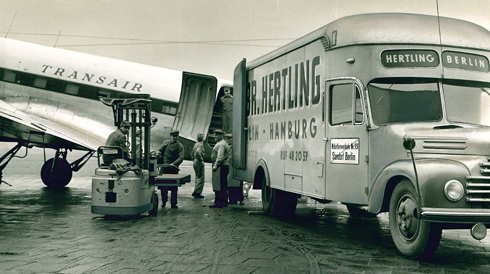 HERTLING historical picture truck at the airport at the airplane in Berlin